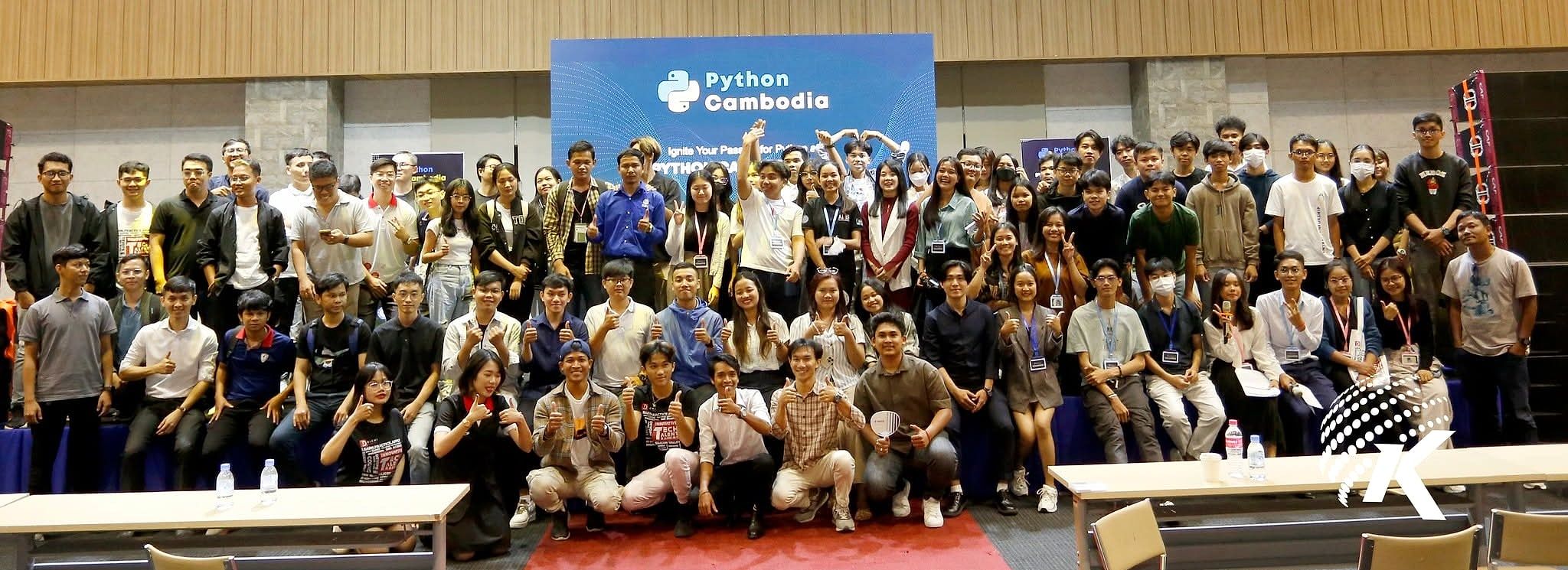 Group photo of participants and organizers at Python Cambodia 2023, gathered in front of the event stage
